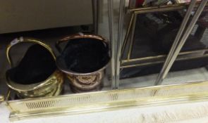 A brass coal bucket, copper coal bucket, a three-fold brass fire screen and a brass fire kerb