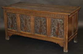 An 18th Century oak coffer, the rectangular top above four floral carved panels on moulded stile