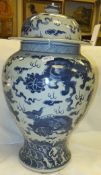 A Chinese blue and white baluster shaped vase and cover with kylin decoration