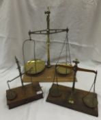 Three sets of brass pan scales, all on wooden bases, one bearing ivorine plaque inscribed "May