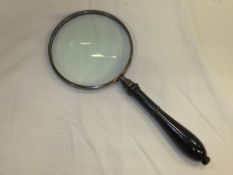 A magnifying glass with ebonised handle*