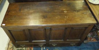 An 18th Century oak mule chest of typical form, the rectangular twin plank hinged top over quadruple