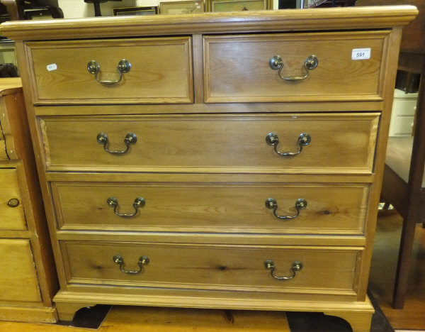 A modern pine chest of two short over three long drawers