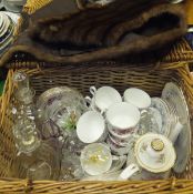 A wicker hamper and contents of a fur stole, glass decanter with star cut base, Colclough part tea