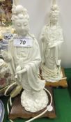 A pair of Chinese blanc-de-chine figures of Guan Yin, raised on carved wood bases (now mounted as