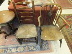 A 19th Century low back Windsor armchair and an ash rush seat ladder back rocking chair