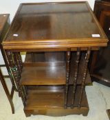 A mahogany revolving bookcase with spindle turned ends and square central column