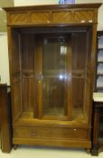 A stained pine display cabinet with adjustable shelves, two glazed doors with single drawer below (