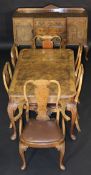 A 20th Century walnut dining suite in the 18th Century taste comprising rectangular table with