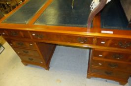 A yew veneered pedestal nine-drawer desk with blue leather top   CONDITION REPORTS  Some scratches