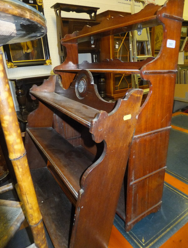 A mahogany wall mounted shelf unit, and another similar in walnut, together with a vintage