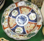 A Japanese Imari lobed dish with central underglaze blue medallion within a polychrome decorated