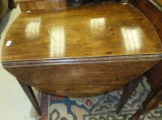 An early 19th Century mahogany oval drop-leaf Pembroke table with square tapering legs