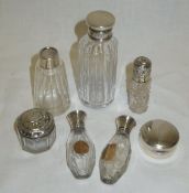 A collection of nine small cut glass dressing table jars and bottles with silver mounts