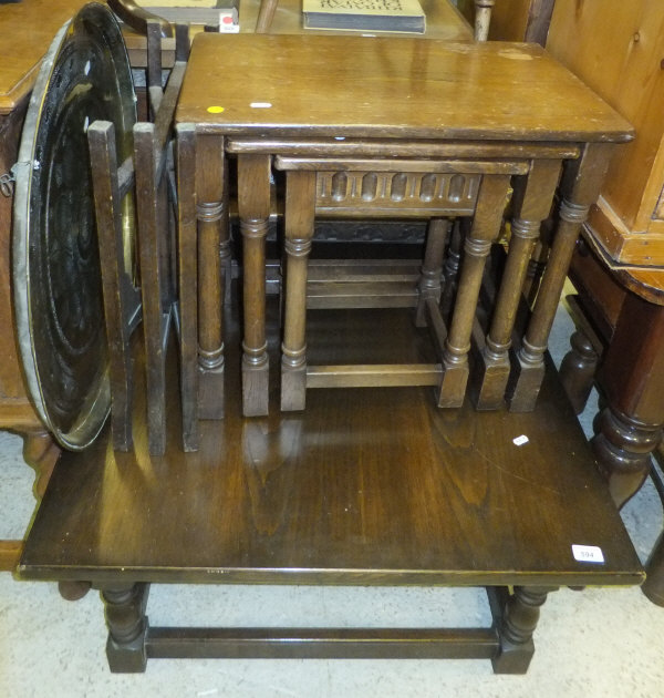 A square oak coffee table, a nest of three oak occasional tables, and a circular brass Benares style