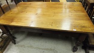 A 19th Century pine kitchen table, the plank top over two end drawers on a stained base with