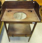 A 19th Century mahogany wash stand, the three-quarter splash back top over an undertier with