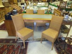 A modern glass topped pine dining table, four cane chairs and a matching mirror