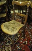A set of four Victorian walnut bedroom chairs with caned seats