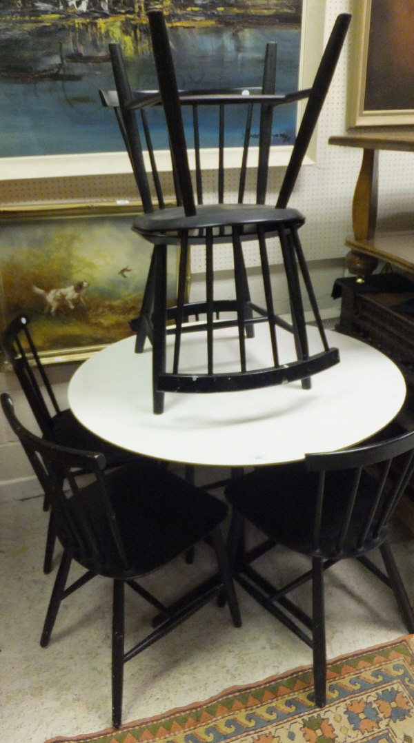 A 20th Century circular kitchen table with white laminate top, together with a set of six black