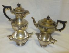 A George V silver four piece tea set comprising teapot, water jug, creamer and sugar basin with