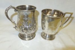 A Victorian silver christening mug with embossed decoration (London 1869), together with a further