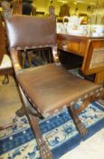 A mahogany side chair with cross-framed sides and brown leather seat and back, the legs with