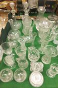 A collection of various cut glass jugs, decanters, drinking glasses, etc