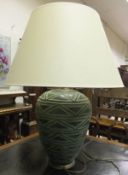 A large ovoid ceramic table lamp base with cream shade