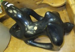 A modern black sculptural model of a naked woman in the Henry Moore manner