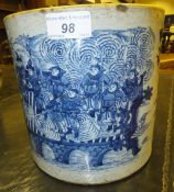 A Chinese porcelain cylindrical pot decorated in under glaze blue with figures on a bridge and