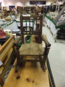 A child's elm and beech framed rocking chair with rush seat