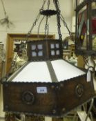 A hammered copper six sided hanging lantern in the Arts and Crafts taste with opaque glass shaped