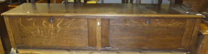 An early 20th Century oak rectangular shoe cabinet / bench seat, the two fall front doors opening to
