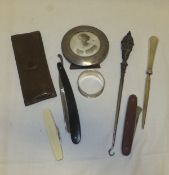 A box containing a silver photograph frame, silver letter opener, silver handled button hook, etc.