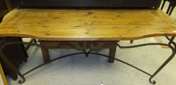 A modern pine wrought iron framed table