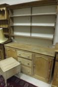 A 19th century pine dresser base with central arrangement of three drawers flanked by pointed arch
