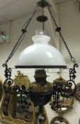 A Victorian brass and black wrought iron hanging lantern with opaque glass shade and clear glass