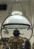 A Victorian brass bodied ceiling gas light with opaque glass shade and clear glass flue