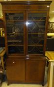 A modern reproduction mahogany and cross-banded bookcase cabinet in the George III taste