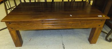 An Indian hardwood rectangular coffee table raised on square supports
