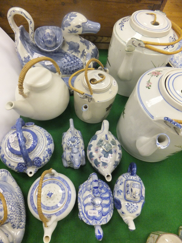 A large collection of Chinese porcelain novelty teapots to include ducks, camel, tortoise, etc