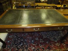 A large mahogany library table with three drawers to either side with dark leather top, the whole
