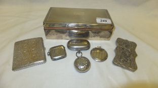 A silver cigarette case, silver vesta case, plated sovereign holder, two plated pill boxes, Indian