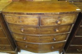 An early 19th Century mahogany bow fronted chest of two short and three long drawers on splayed