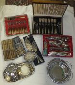 A box of assorted plated wares to include various cased sets of cutlery, pierced galleried trays,