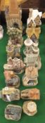 A collection of 14 David Winter cottage ornaments to include Gateway to Prague, Mr Brownlow's, The