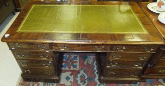 A mahogany double pedestal desk, the top with tooled and gilded writing surface and moulded edge