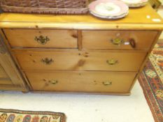 A modern pine chest of two short and two long drawers