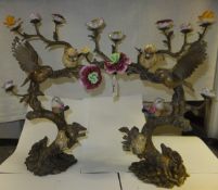 A pair of gilt metal ornaments with porcelain bird and flower embellishments